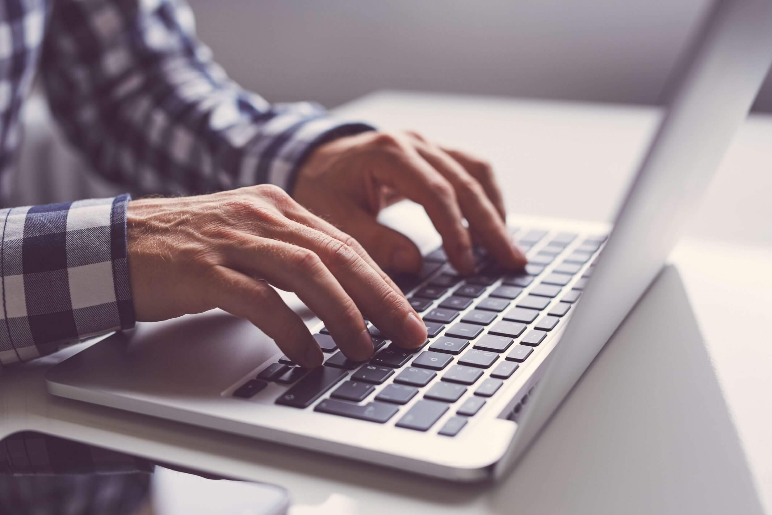 Man typing on laptop